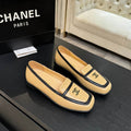 Pre-owned Chanel CC logo beige and black leather loafers displayed with original Chanel Paris box