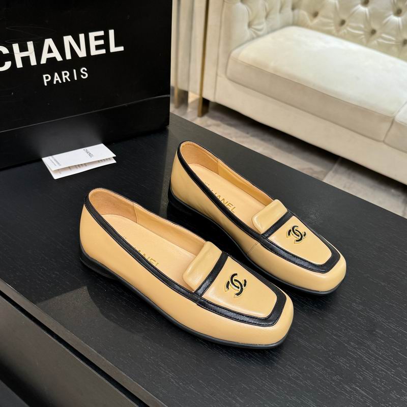 Pre-owned Chanel CC logo beige and black leather loafers displayed with original Chanel Paris box