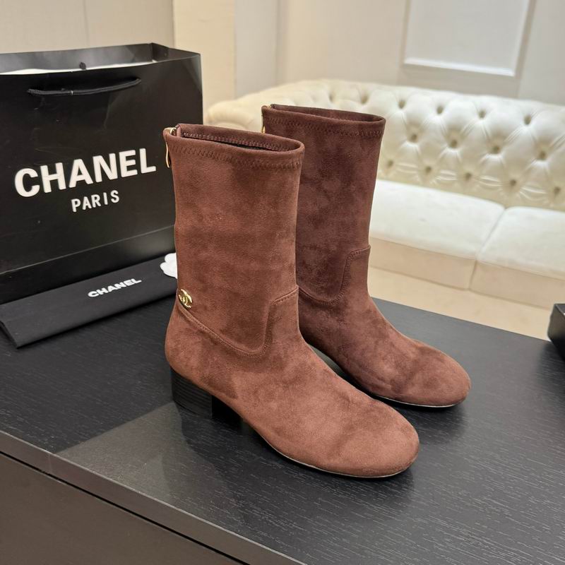 Chanel brown suede mid-calf boots with gold CC logo, displayed with Chanel Paris shopping bag